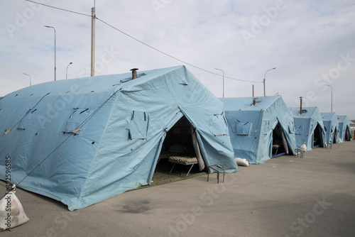new tents for refugees from Ukraine.mobile building, temporary refugee camp.refugee camp.isolation tent at the refugee distribution center.Refugee boot camp photo