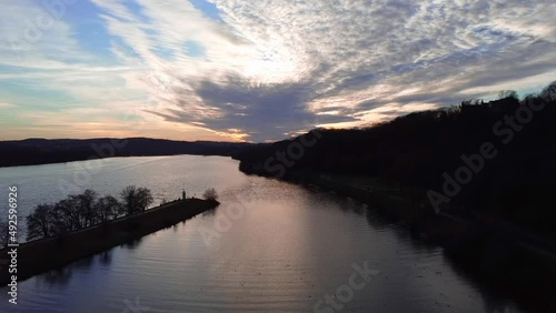 Aerial dron view of lake, water and silhouette of trees during sunset. Evening nature, beautiful landscape. FullHD footage