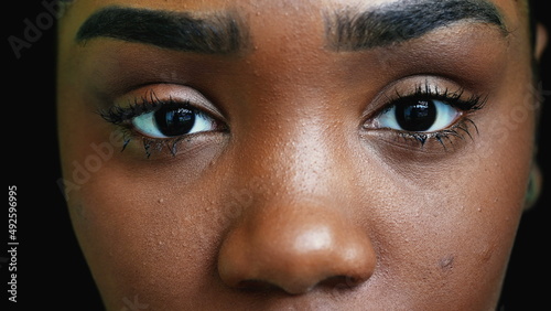 A black teen girl closing eyes in meditation person opening eye macro close-up photo