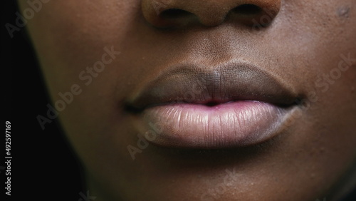 A black girl close-up mouth an african woman face macro