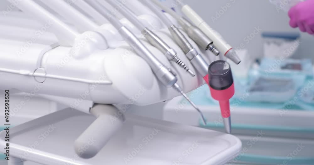 gloved hands of a stylistically dressed person move part of the unit