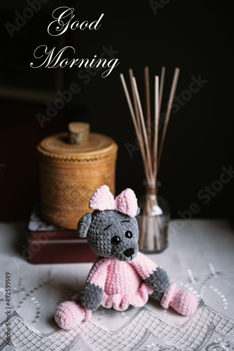 Stuffed toys on the table with the text of the greeting "Good morning".