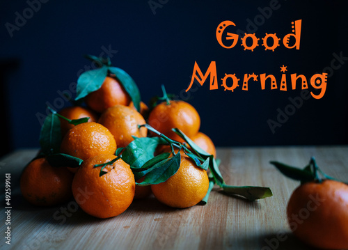 The inscription good morning. Orange tangerines on the table