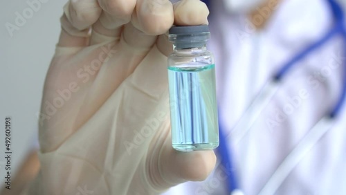 Infectious doctor show COVID 19 vaccine for prevention, immunization and treatment for new corona virus infection. Medical technology concept