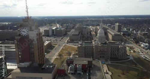 Michigan state capitol building with Boji Tower in Lansing, Michigan. Drone video moving sideways. photo