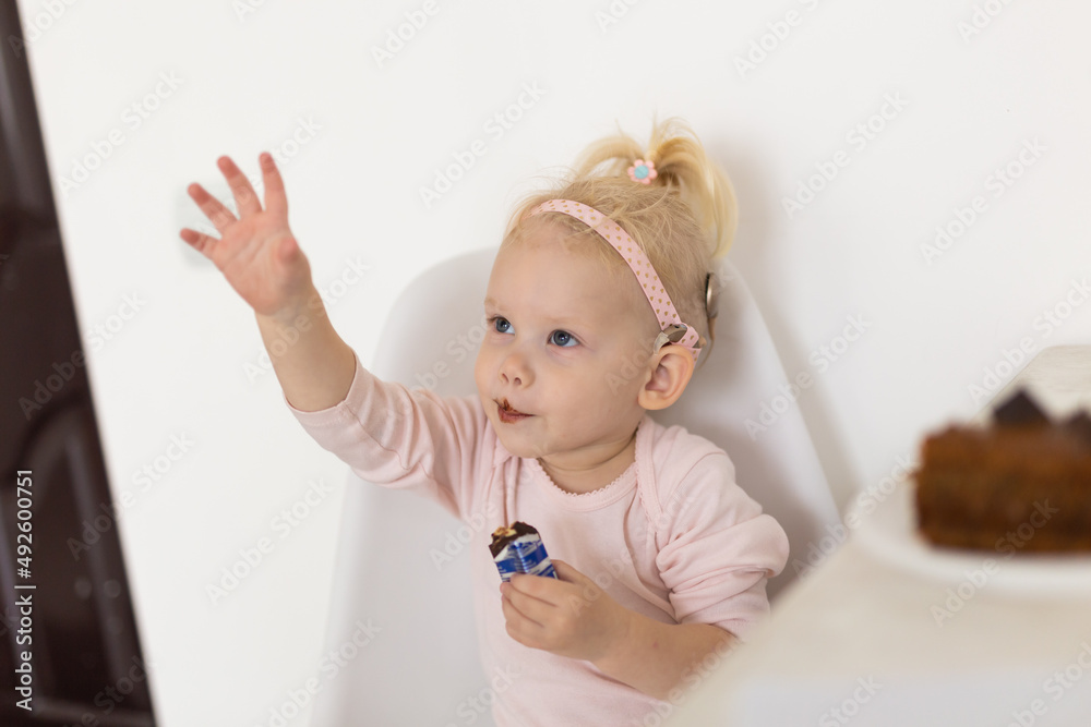 Baby with cochlear implants at home. Deafness and medical technology concept. Baby with cochlear implants at home. Deafness and medical technology concept.