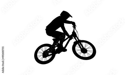 Fototapeta Naklejka Na Ścianę i Meble -  Downhill Mountain Biker Jumping Bicycle. Very Clean File. Image Is One Single Vector Shape.