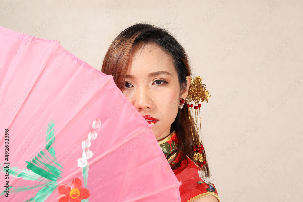 attractive young woman wearing retro Chinese cheongsam dress standing posing colourful paper umbrella attractive young woman wearing retro Chinese cheongsam dress standing posing colourful paper umbrella