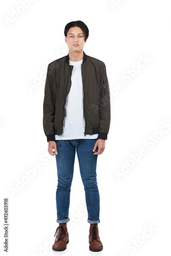Hes super casual. Full length portrait of a young man standing against a white background.