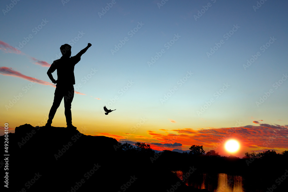 silhouette tourists watching the sunset on the mountain. beautiful silhouette sunset in the river view. silhouette tourists watching the sunset on the mountain. beautiful silhouette sunset in the river view.