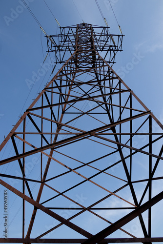 High Voltage Power Line Tower on the Blue Sky Background