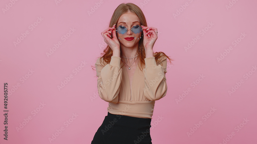 Portrait of seductive cheerful businesswoman girl in beige blouse wearing sunglasses, charming smile. People emotions concept. Young lovely adult woman posing isolated on pink studio wall background