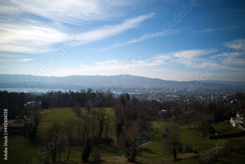 Aerial view over City of Zürich with local mountain Uetliberg and Lake Zürich in the background on a sunny spring day. Photo taken March 1st, 2022, Zurich, Switzerland.