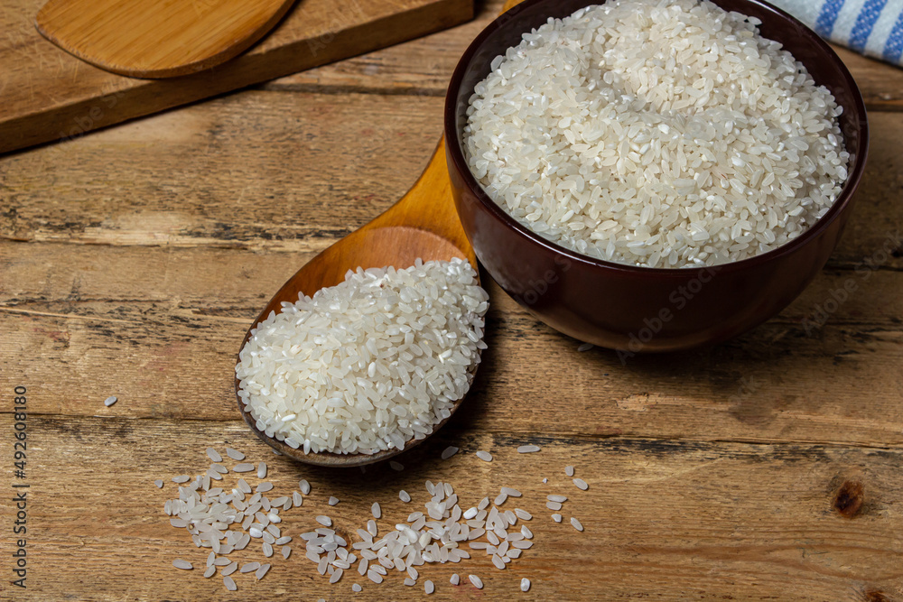 Rice in a plate on a wooden background. Traditional rice dish. dry rice
