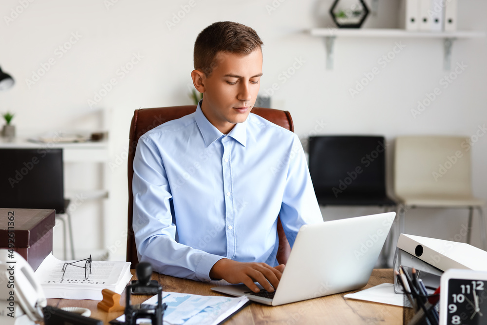 Young male notary public working in office Young male notary public working in office