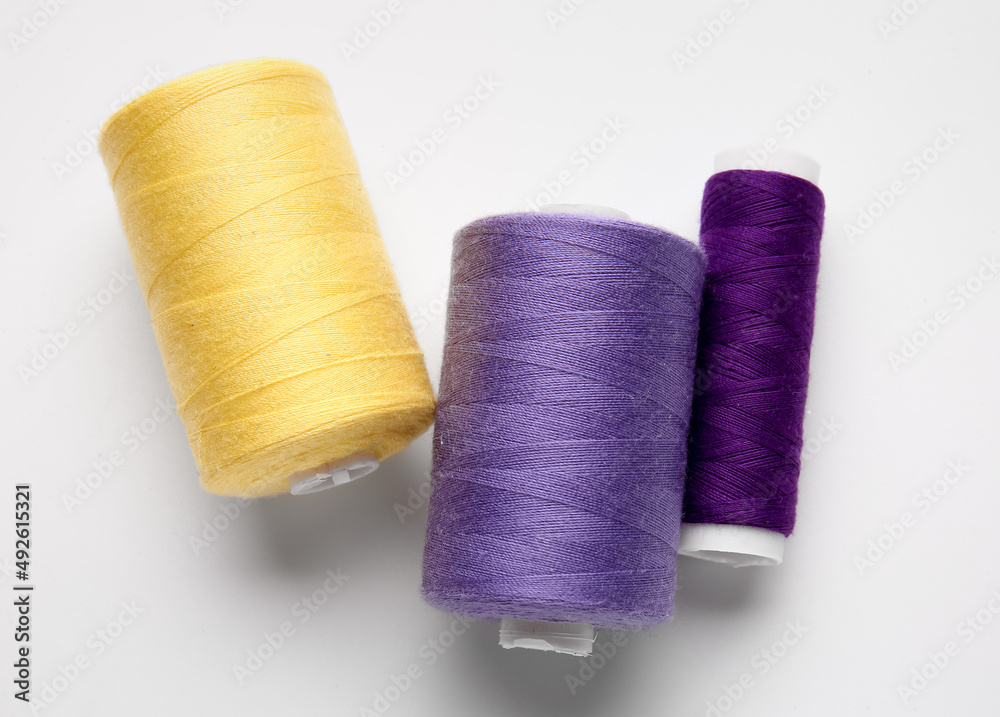 Different thread spools on white background Different thread spools on white background