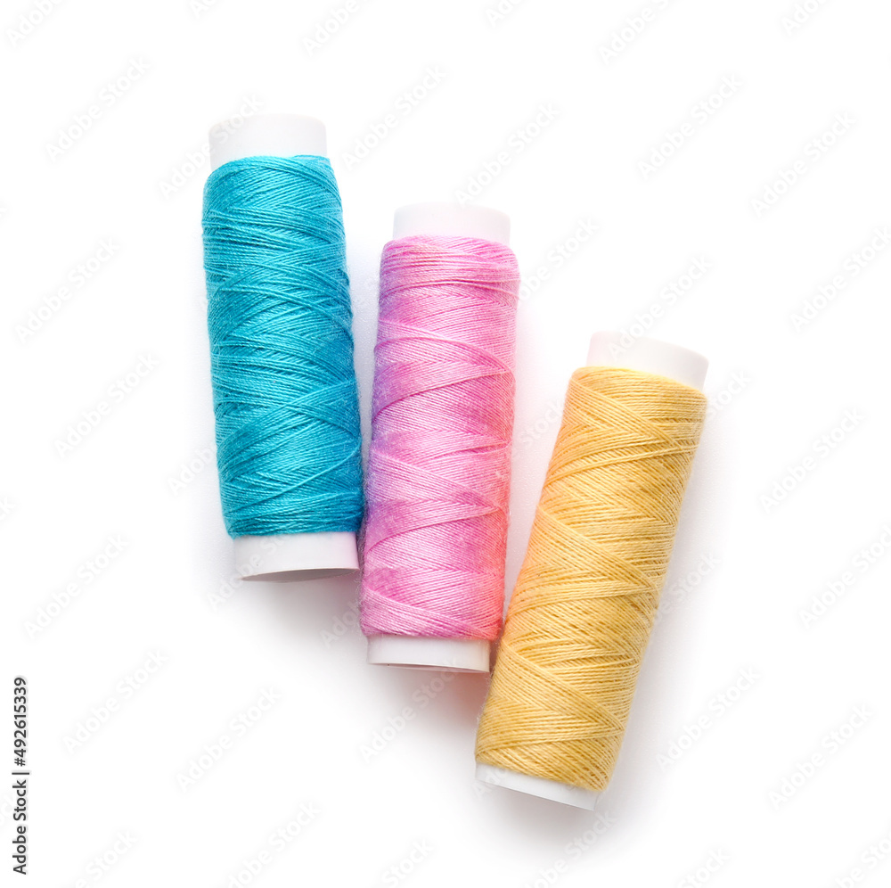 Different thread spools on white background Different thread spools on white background