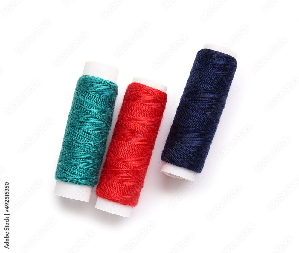 Different thread spools on white background Different thread spools on white background