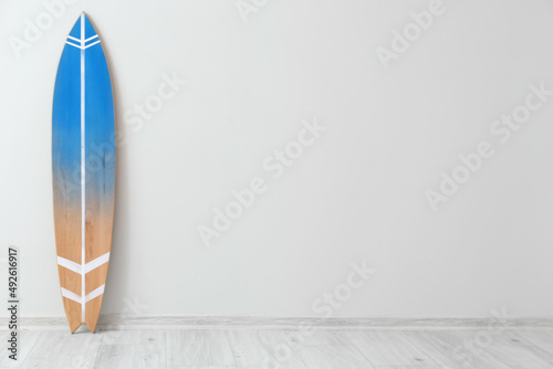 Photography Wooden surfboard near light wall