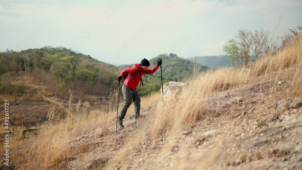 Confident and powerful man with backpack hiking walking on rocky mountains at vacations outdoor. Man traveler mountaineering on adventure trip in natural at holidays. Travel lifestyle concept Confident and powerful man with backpack hiking walking on rocky mountains at vacations outdoor. Man traveler mountaineering on adventure trip in natural at holidays. Travel lifestyle concept