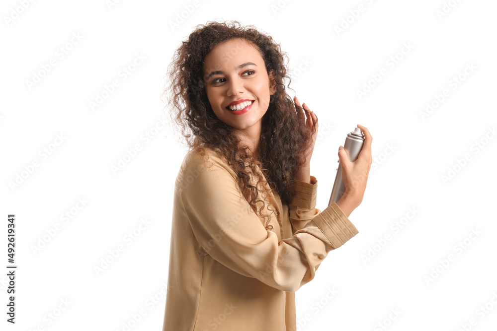 Pretty young African-American woman with hair spray on white background Pretty young African-American woman with hair spray on white background