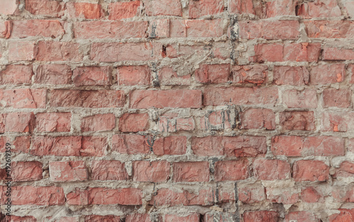 Abstract texture  horizontal brick tile background. Old and weathered red brick wall close up. Vintage house facade.