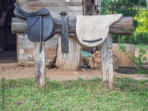 Ancient rural stable and horse saddle