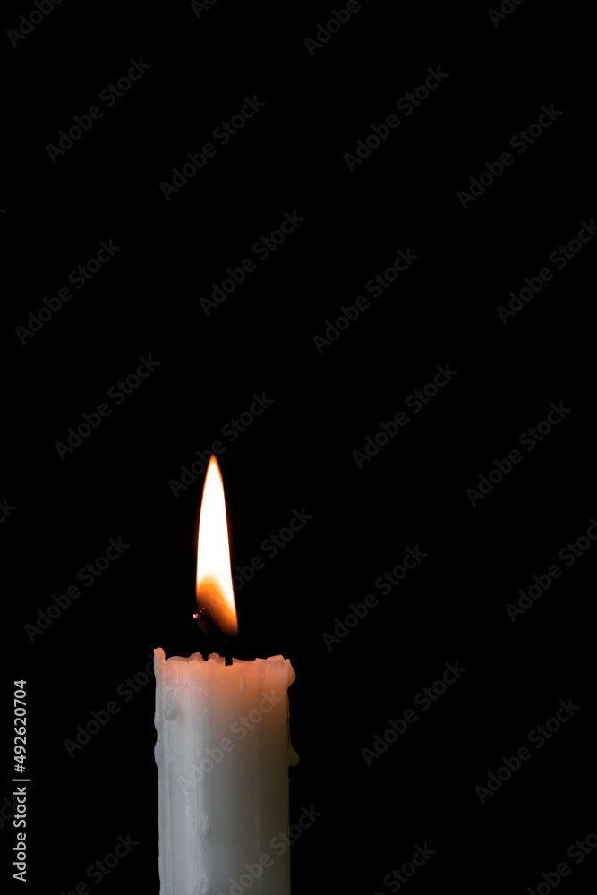 white burning candle on a black background, a symbol of sadness and sorrow, memory of the dead, war concept white burning candle on a black background, a symbol of sadness and sorrow, memory of the dead, war concept
