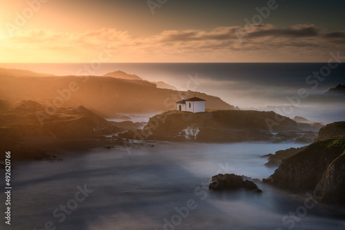 Incredible hermitage on the coast at sunset photo