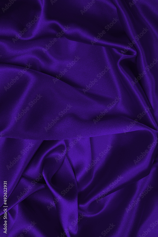 Fototapeta premium Violet silk or satin luxury fabric texture.