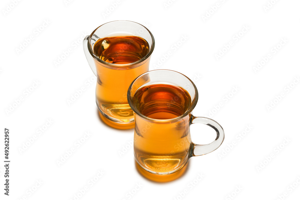 A turkish glass of tea isolated on white background. A turkish glass of tea isolated on white background.