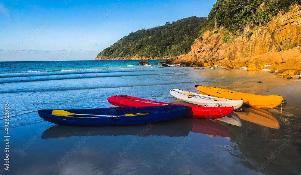 Obraz premium Redang Island, Malaysia Colourful Kayak boats on the beach ready to be sailed early in the morning