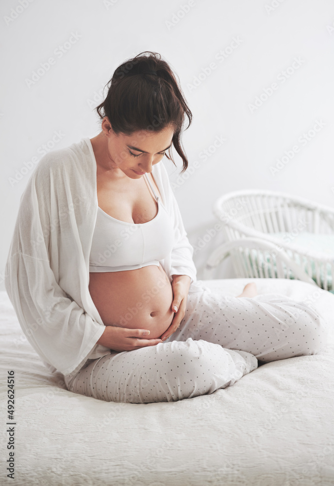 Are you doing somersaults in there. Shot of a pregnant woman at home. Are you doing somersaults in there. Shot of a pregnant woman at home.