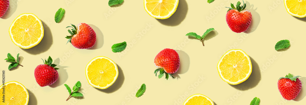 Fresh lemons and strawberries with mints overhead view - flat lay Fresh lemons and strawberries with mints overhead view - flat lay