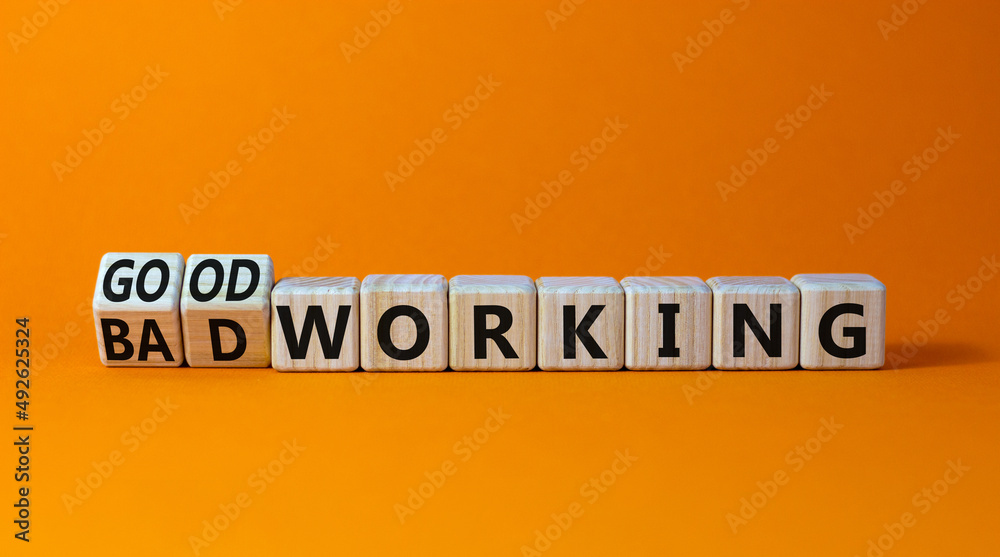 Good or bad working symbol. Turned wooden cubes and changed words bad working to good working. Beautiful orange table orange background. Business good or bad working concept, copy space. Good or bad working symbol. Turned wooden cubes and changed words bad working to good working. Beautiful orange table orange background. Business good or bad working concept, copy space.