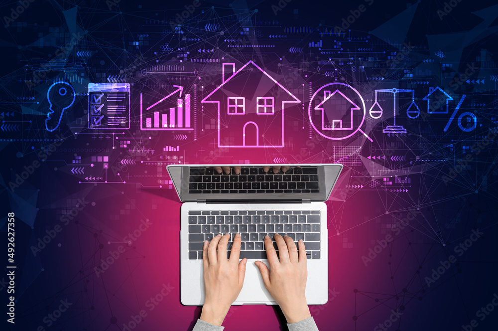 Real estate theme with person using a laptop computer - obrazy, fototapety, plakaty 
