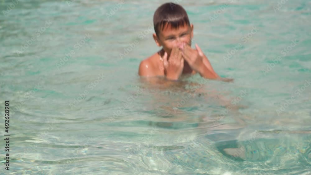 the boy dives in the pool under the water surfacing shows the class.. an asterisk. relax in the outdoor pool the boy dives in the pool under the water surfacing shows the class.. an asterisk. relax in the outdoor pool
