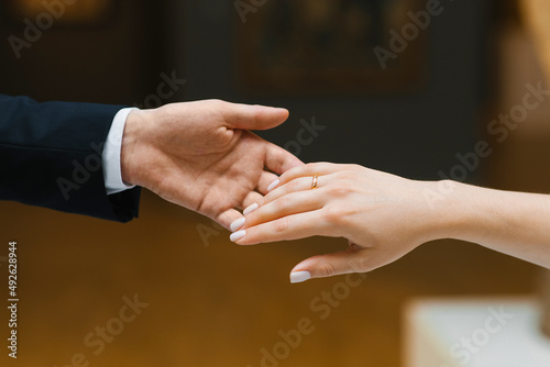 The groom extends his hand to the bride. Close-up
