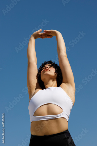 Young Latina girl stretching before exercise and Yoga