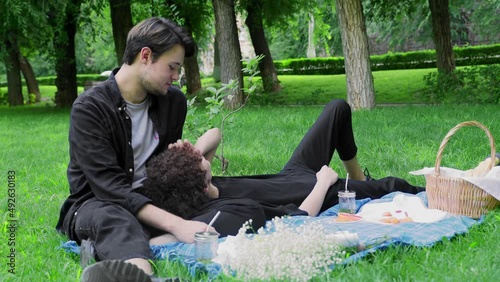 Two guys had a picnic in nature in the summer and relaxed. LGBT