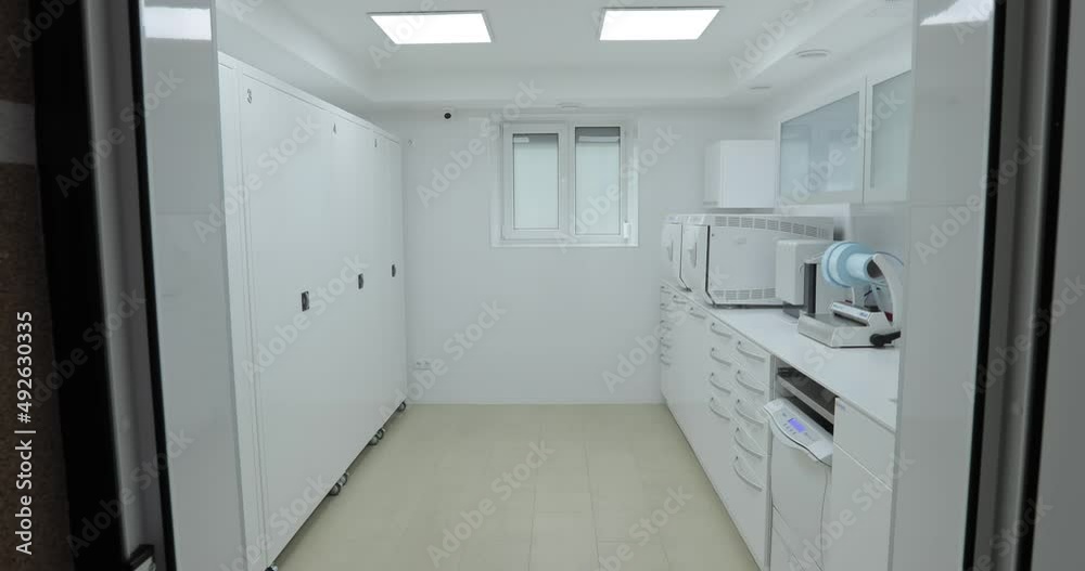 smooth departure of the camera from the steadicam from the laboratory and the sterilization room in the dental clinic. overall plan smooth departure of the camera from the steadicam from the laboratory and the sterilization room in the dental clinic. overall plan