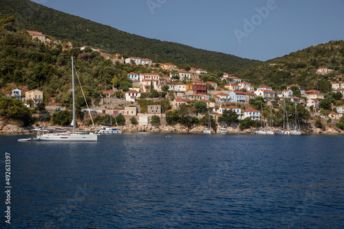 View of colorful houses and anchored sailing boats off the coast of the ITHACA island, KIONI Bay, Ionian Islands, Greece in summer sunny day.