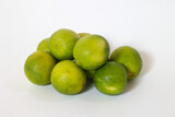 A group of ripe green and yellow whole limes isolated on white background. tropical citrus oganic fruit with hight c vitamin