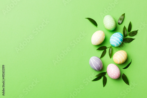 Colorful Easter eggs with spring flower leaf isolated over white background. Colored Egg Holiday border