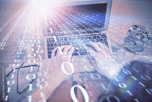 Double exposure of man's hands typing over computer keyboard and data theme hologram drawing. Top view. Technology concept.