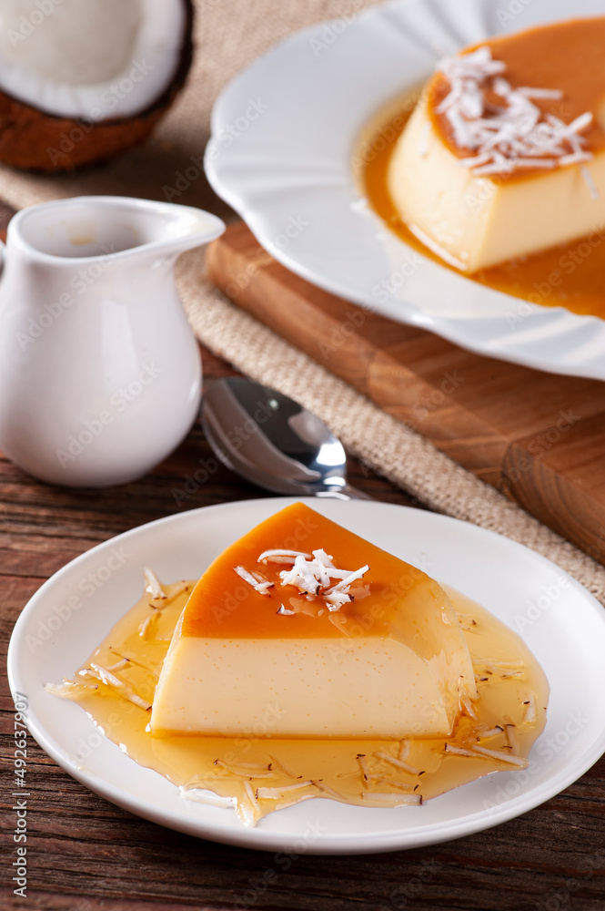 Fototapeta premium Delicious condensed milk and coconut pudding on a white plate.