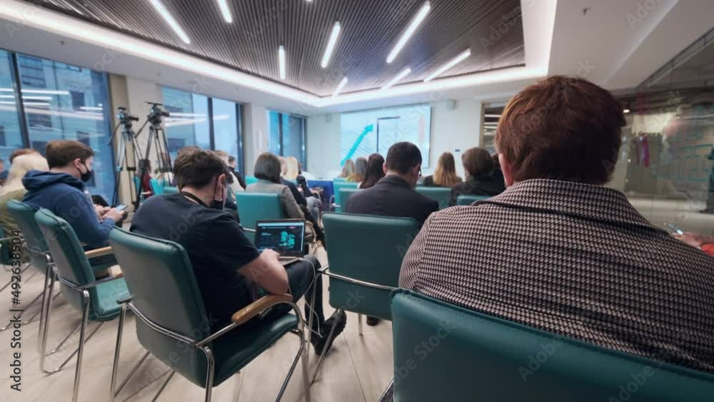 People using devices and watching presentation