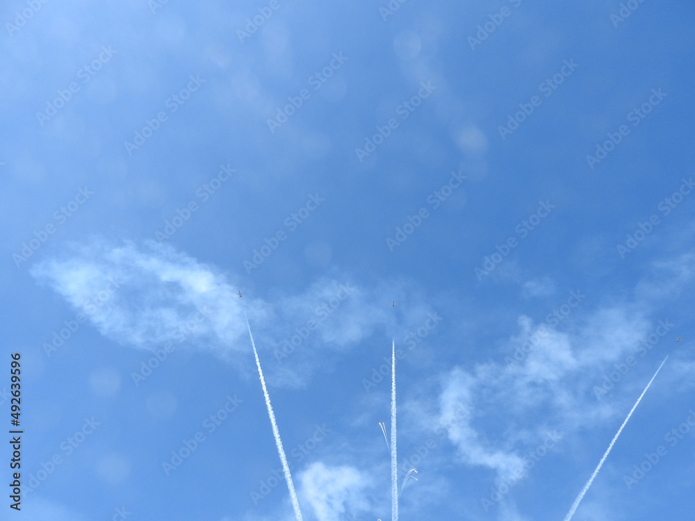 Aircraft performing aerobatic stunts at an airshow in the skies of southern California.