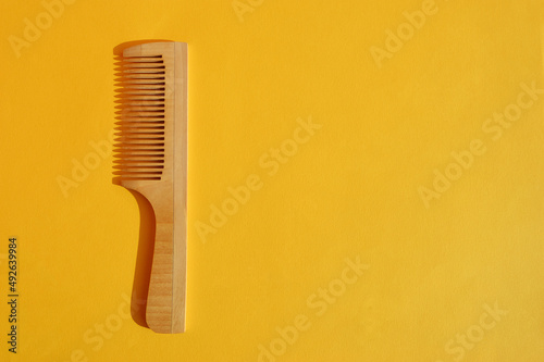 a comb for hair on a yellow background. a barbershop item.