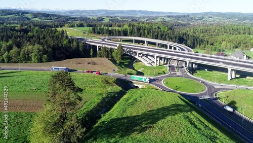 New highway in Poland on national road no 7, E77, called Zakopianka.  Overpass crossroad with a traffic circle, slip roads and viaducts near Skomielna Biala. Aerial video. Far view of Tatra Mountains photo